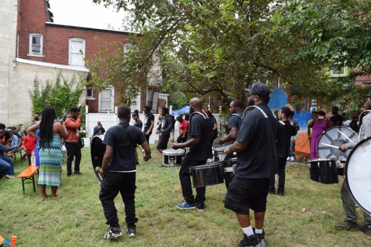A drill team proceeded through the alley into the lot, drawing big crowds