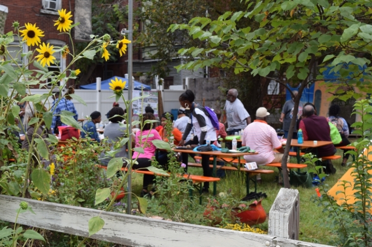 People eating at picnic tables at Bartram's Garden