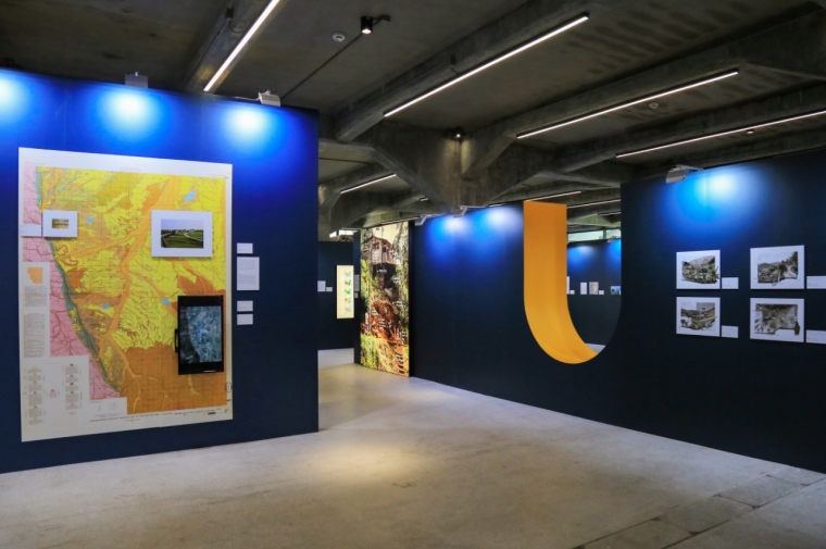 Illuminated gallery with maps on walls