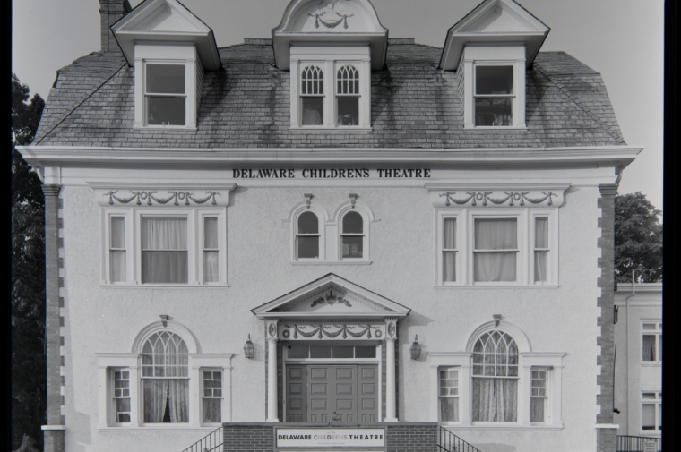 White 3-story facade with sign "Delaware Childrens Theatre" in B&W photograph