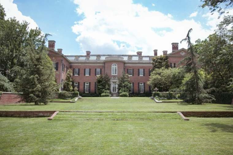 Rolling lawn with brick residence in the distance