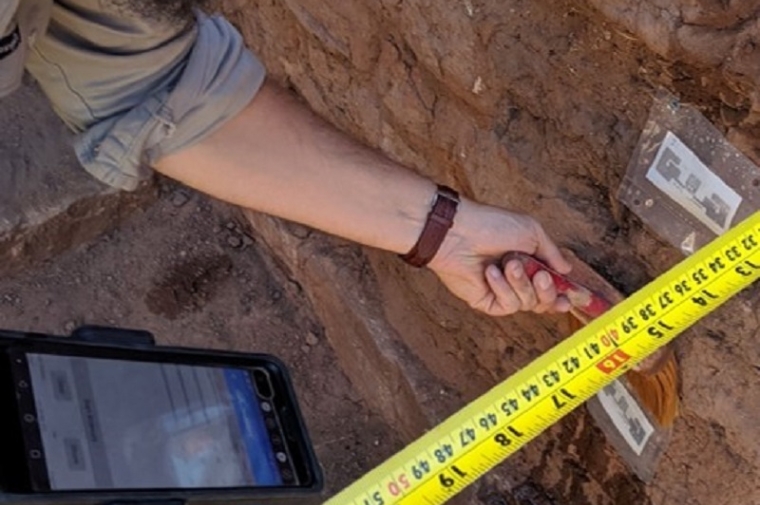Evan Oskierko-Jeznacki taking measurements with a RFID scanner at Fort Union National Monument, New Mexico