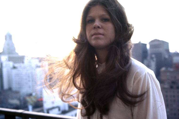 A woman posing for the camera on a rooftop