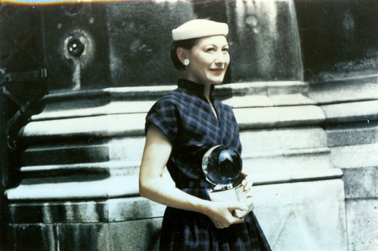 A woman holds an award