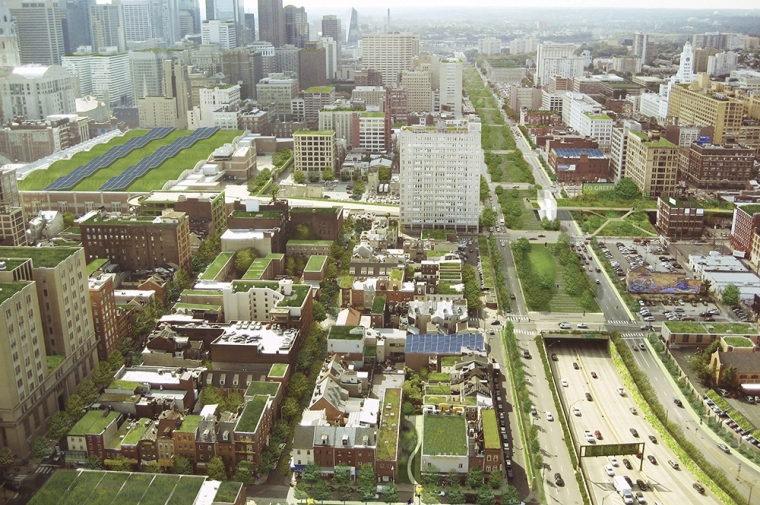 Low rise and high rise buildings with green roofs next to a highway