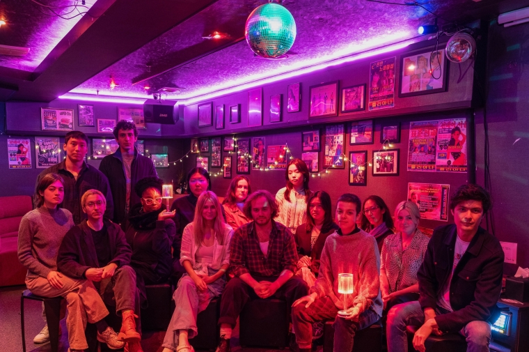 Group seated at neon-lit lounge