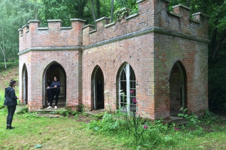 Liz Trumbull and Zara Bhatti record dimensions of the Garden House, a Gothic structure located in Powderham's American Garden. Photo: Starr Herr-Cardillo.                       