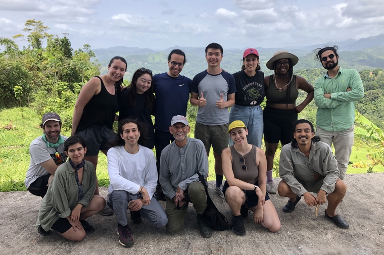 A group of students and Pujol posing for a group portrait
