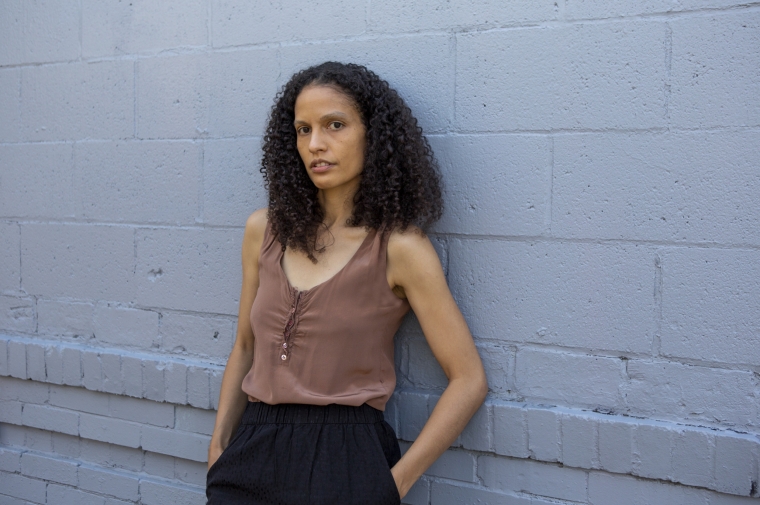 Photo of Jessica Vaughn leaning against a gray wall