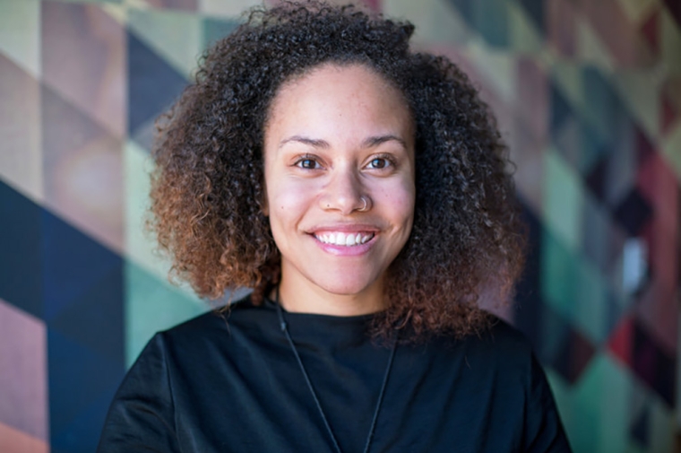 Headshot image of speaker in front of patterned background