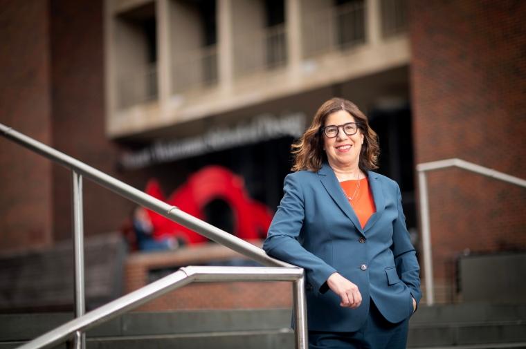 Leslie Richards in front of red brick building