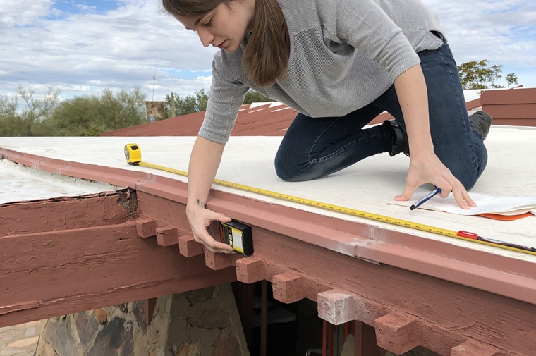 Mia Maloney conducts an assessment on the wooden features of the Original Dining Room at Taliesin West in January of 2019. In order to understand the degree of deterioration of the four projecting beams, moisture content readings are recorded and mapped on elevation drawings.