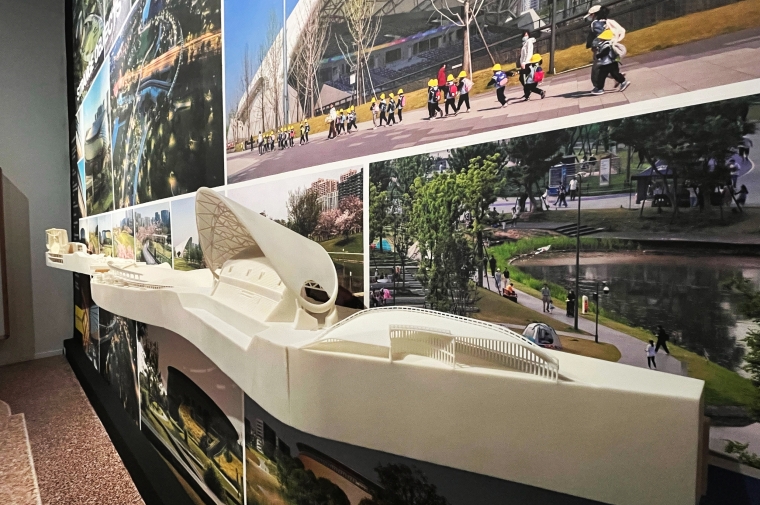 View of serpentine 3D printed architecture model on photo mural