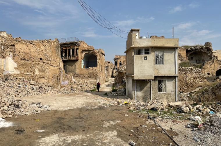 A plaster and brick building in ruins seen in full sun