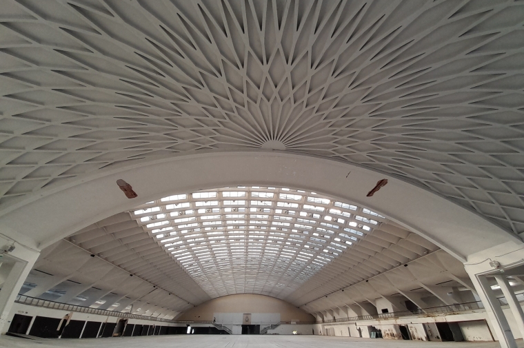 Large arched white dome building with ornamental ceiling