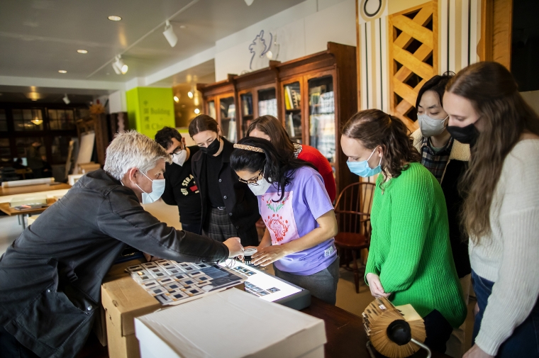 Curator helps student view photo slides on light table