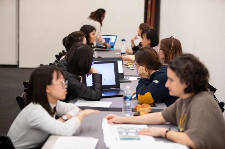 Students and alumni sitting across from each other doing a resume and portfolio review.