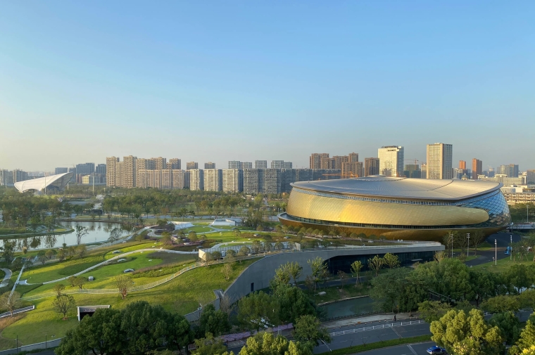 View across park from table tennis stadium to field hockey stadium