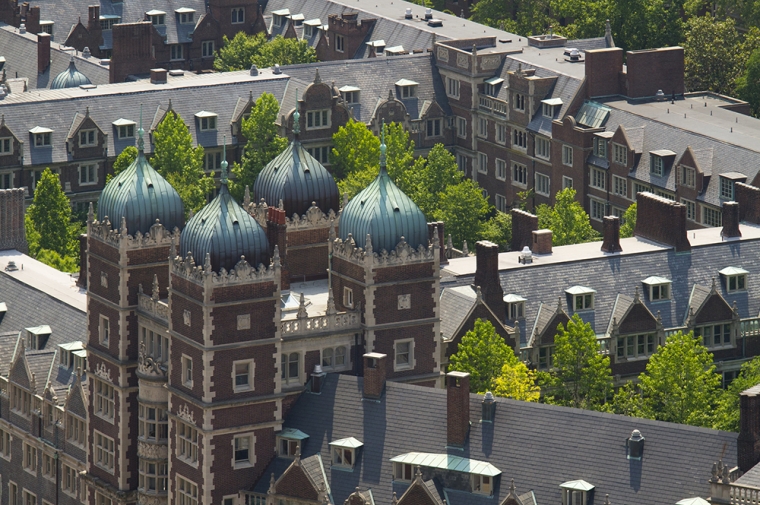 Ornate red and white brick building with green copper rooftops