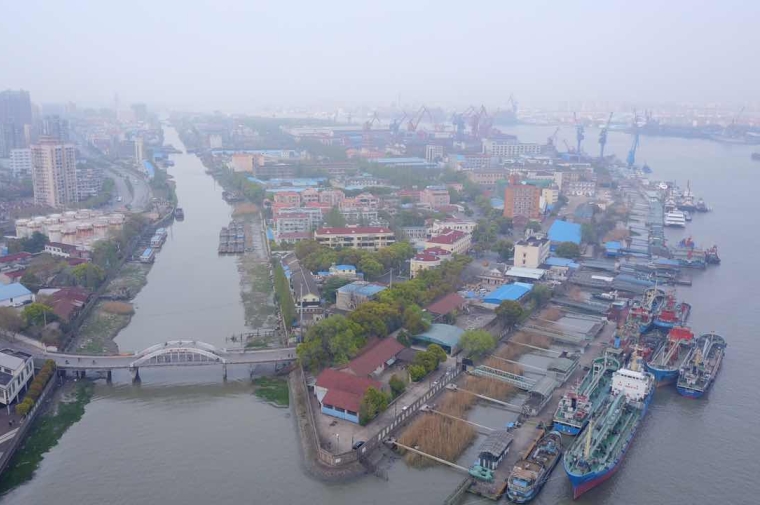 Aerial photo of industrial site between two rivers in hazy conditions