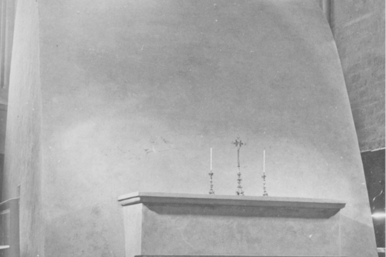 Black and white photo of an altar with candles