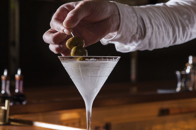 Hand stirring martini glass