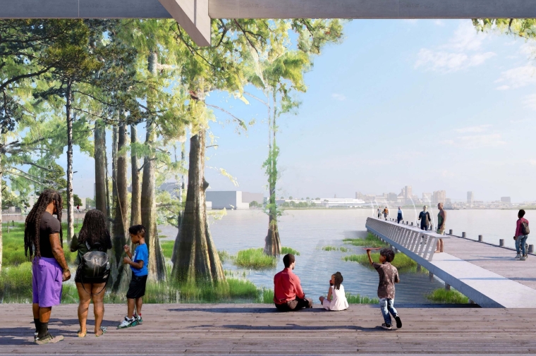People walk out on pier and gather under trees of shoreline park
