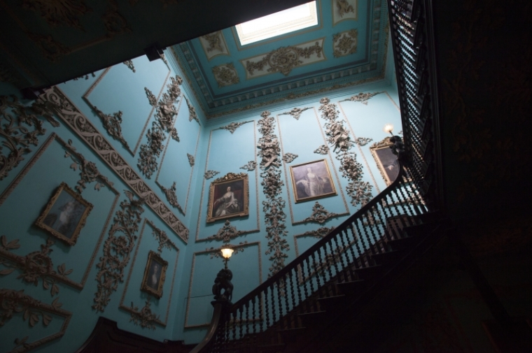 Rococo plasterwork and a vibrant 20th century color scheme adorn the stair hall at Powderham Castle, one of the areas the group studied. Photo: Starr Herr-Cardillo.