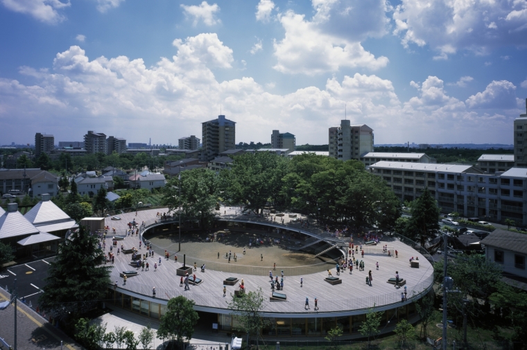 Circular school building with central courtyard under blue sky