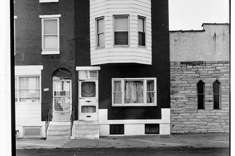 Three-story rowhouse with brick and wood facade