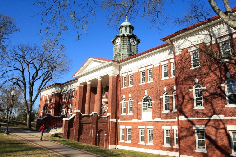 Red brick building with white window frames