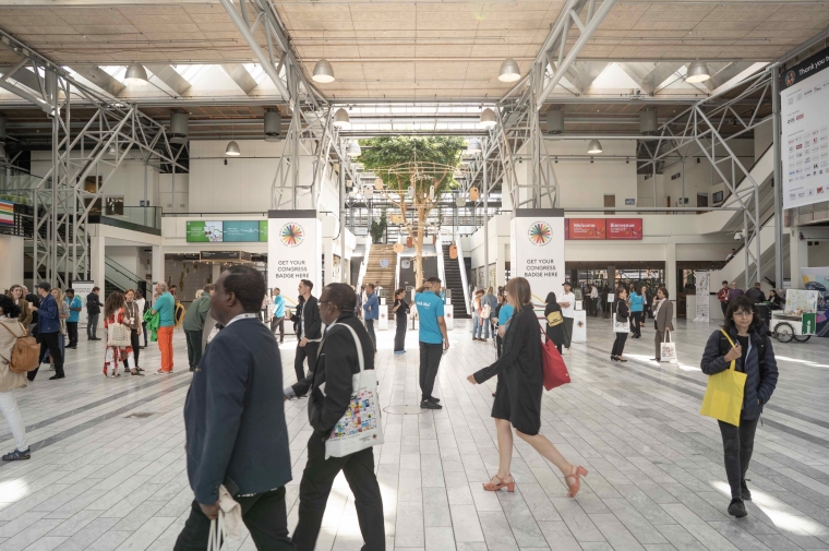 People walking in various directions in exhibition hall