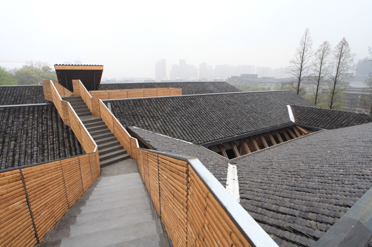 Complex rooftop which includes a walkway with staircase