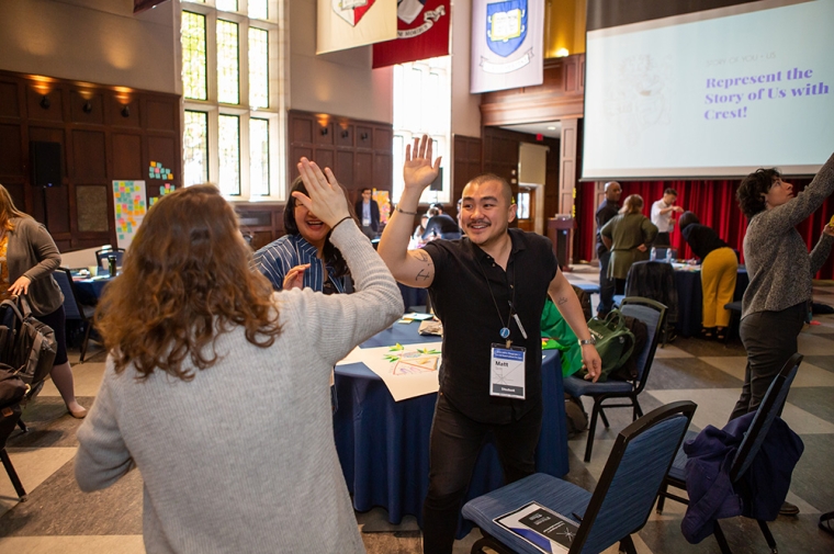 Two students give each other a high five at gathering for XSD