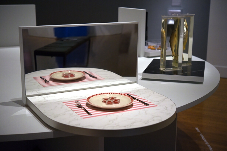 Table setting with food on plate set in front of a mirror