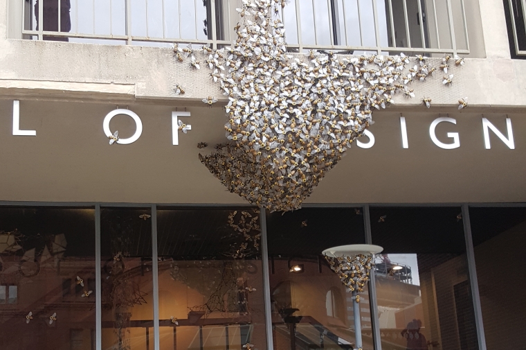 Front of school of design covered in model bees