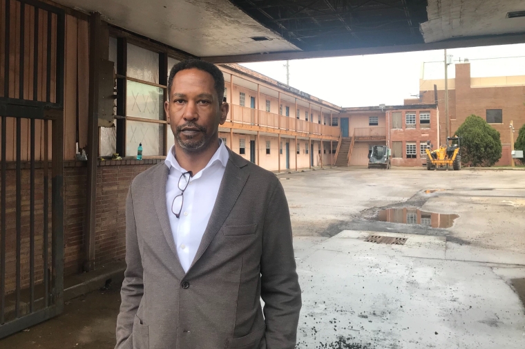 A headshot of Brent Leggs underneath an old building. 