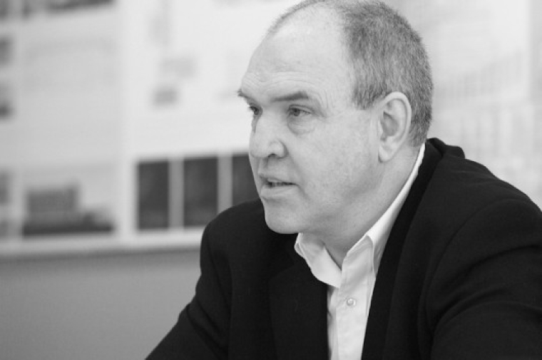 Witold looks to the right in this black and white portrait