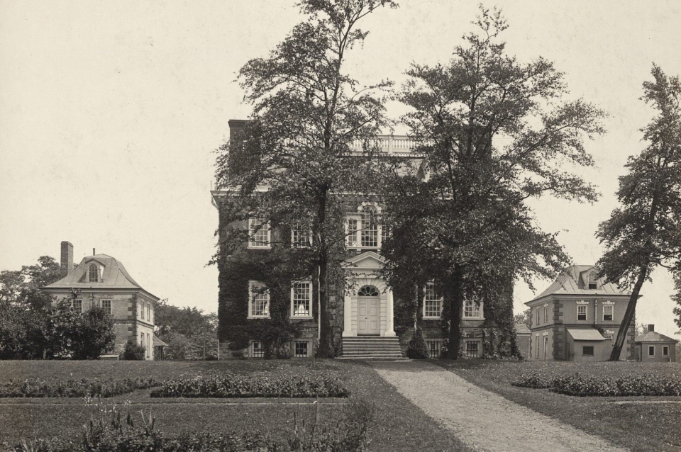 black and white image of house surrounded by lawn