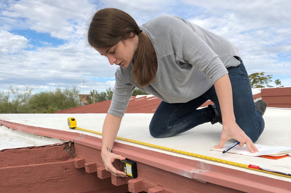 Student measuring on the roof of Taliesin