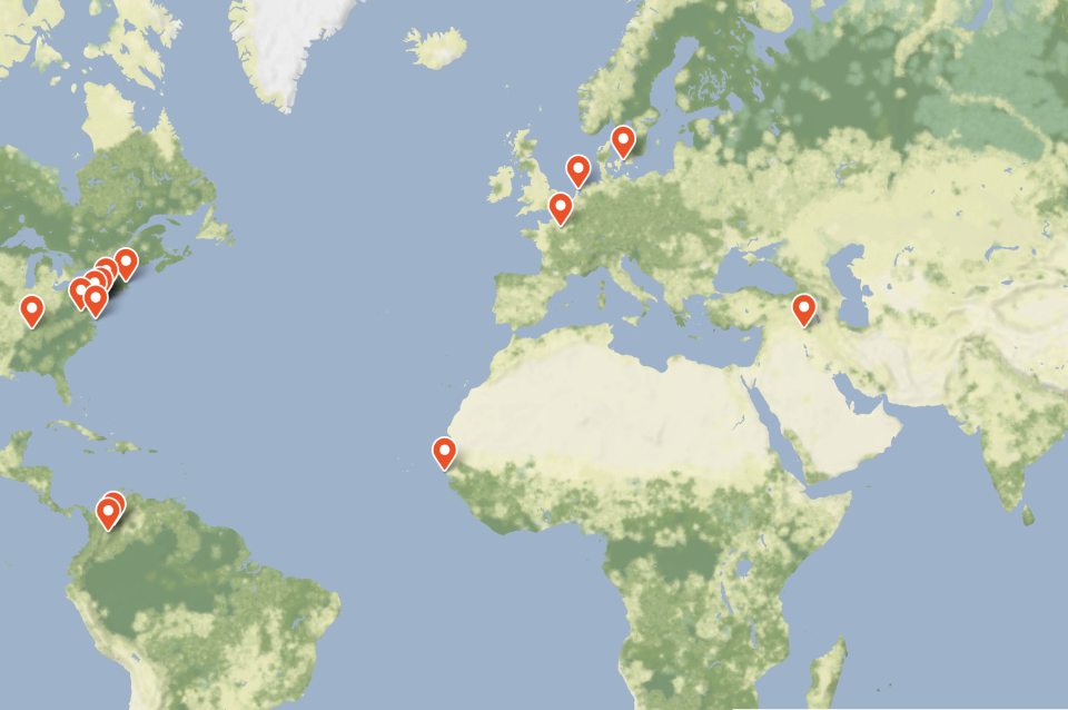 Map of world with red pins in US, South America, Europe, East Asia