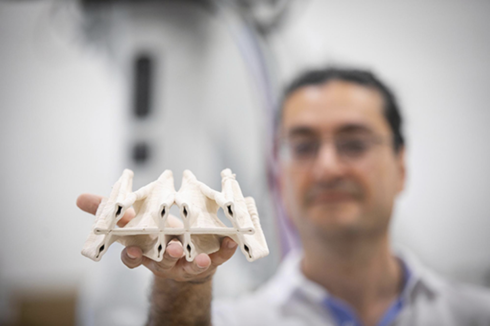 Masoud holding up 3D model