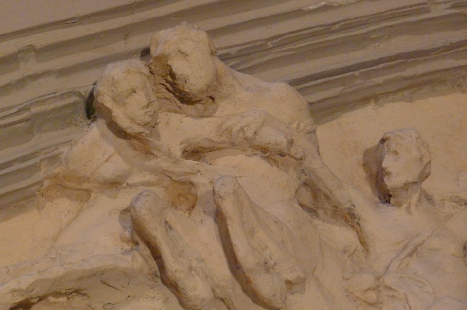 Rough clay sculpture of centaur kidnapping woman