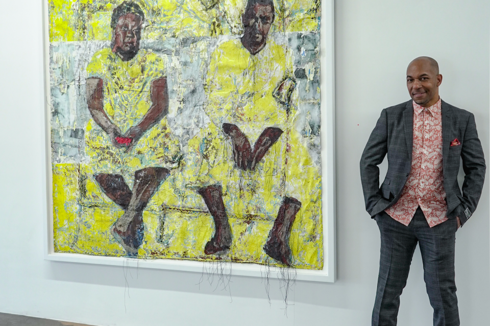 speaker beside large artwork