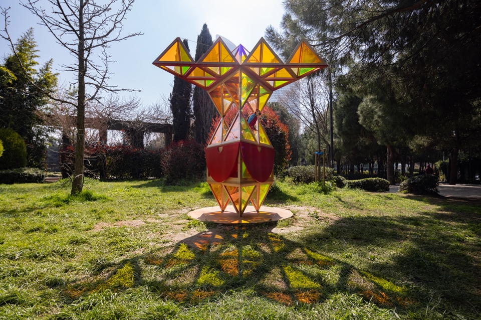 Brightly colored and angled structure in a park setting