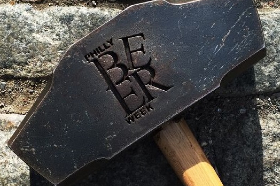 Sledgehammer with "Philly Beer Week" carved in the side.