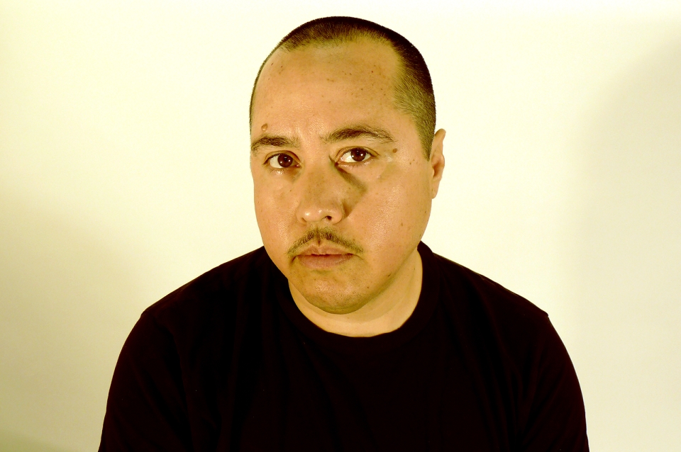 headshot of chris wearing a black shirt against a white background