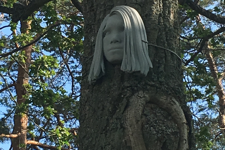 image of Backtroms work, a sculpture of a womans head attached to a tree trunk