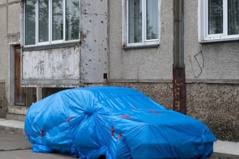 Car wrapped in tarp