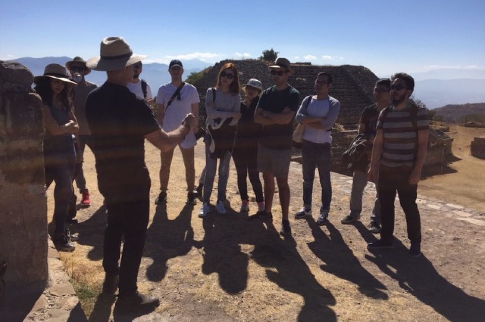 Students gathered and listening to instructor